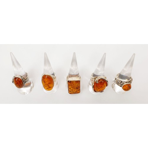 7 - Five silver and amber rings. UK shipping £14. We combine lots.