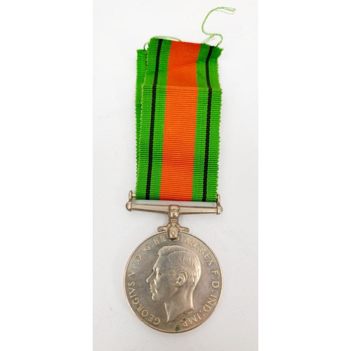 14 - A World War II Defence Medal and ribbon. UK shipping £14.