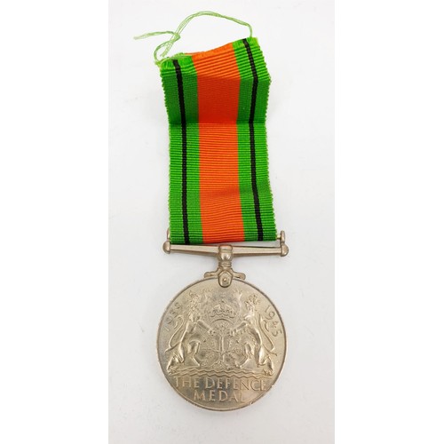 14 - A World War II Defence Medal and ribbon. UK shipping £14.