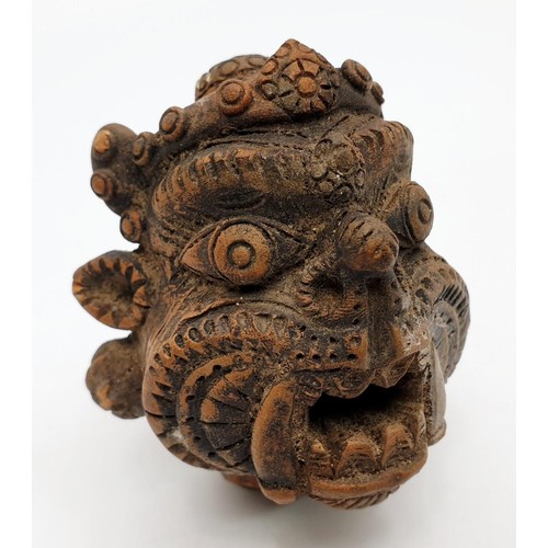 17 - An antique terracotta statue head depicting the Tibetan/Nepalese deity Mahakala, height 2.75