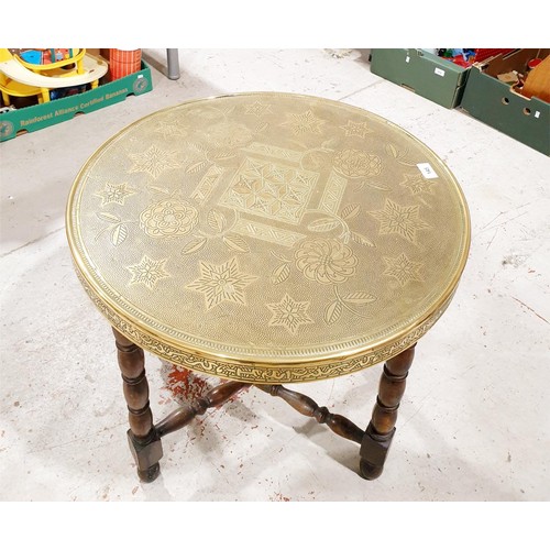 145 - An Islamic style wooden table with a brass top, diameter 23.5