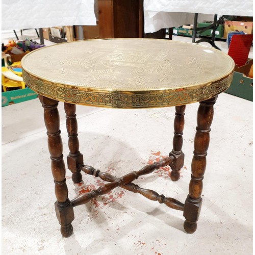 145 - An Islamic style wooden table with a brass top, diameter 23.5