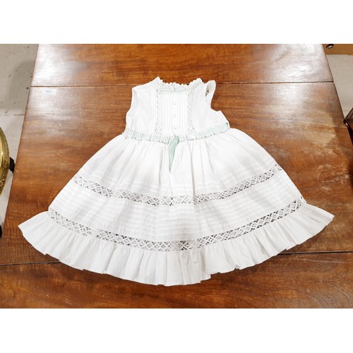 163 - An antique christening gown, a child's dress and a table cloth. UK shipping £14.