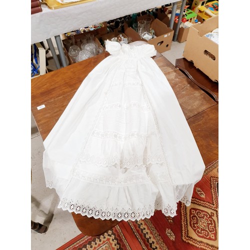 163 - An antique christening gown, a child's dress and a table cloth. UK shipping £14.