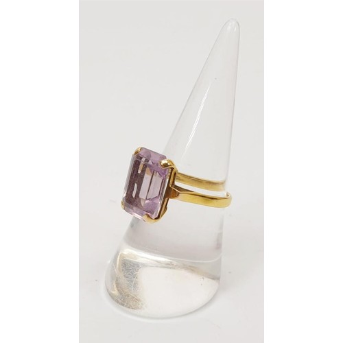 15 - A hallmarked 9ct gold ring set with purple stone, gross weight 3.3g, size N/O. UK shipping £14.