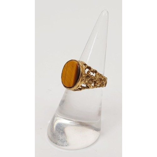 20 - A yellow metal ring set with tigers eye, gross weight 3.7g, size K. UK shipping £14.