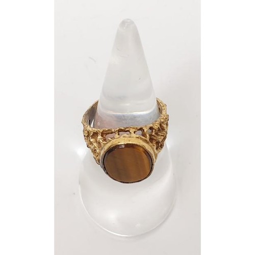 20 - A yellow metal ring set with tigers eye, gross weight 3.7g, size K. UK shipping £14.