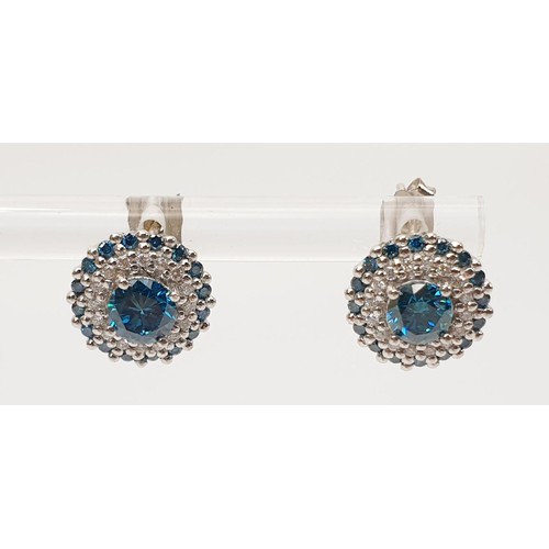 24 - A pair of hallmarked 18ct white gold blue and white diamond cluster earrings, gross weight 2.7g. UK ... 