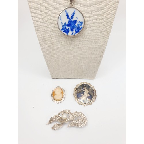 43 - A hallmarked silver cameo brooch, a silver Niello work brooch, one other brooch and a silver pendant... 