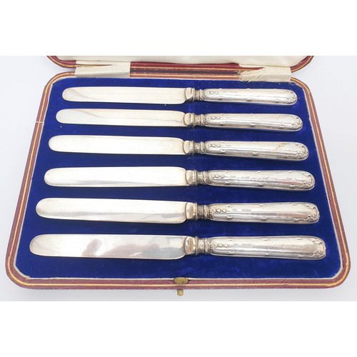 55 - A cased set of six butter knives with hallmarked silver handles, Birmingham 1912, a hallmarked silve... 