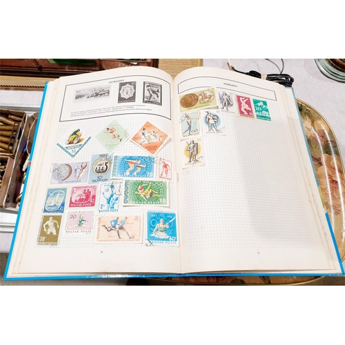 114 - A stamp album and loose stamps. UK shipping £14.