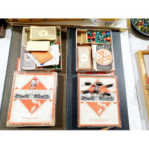 214 - An early Monopoly set and a war production Monopoly set which includes card dice spinner. UK shippin... 