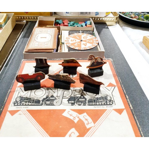 214 - An early Monopoly set and a war production Monopoly set which includes card dice spinner. UK shippin... 