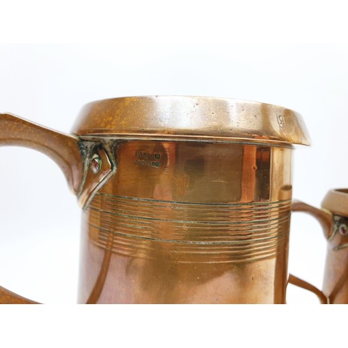 249 - Two Edwardian brass court tankards one a quart the other a pint by Farrow & Jackson, the tallest 6