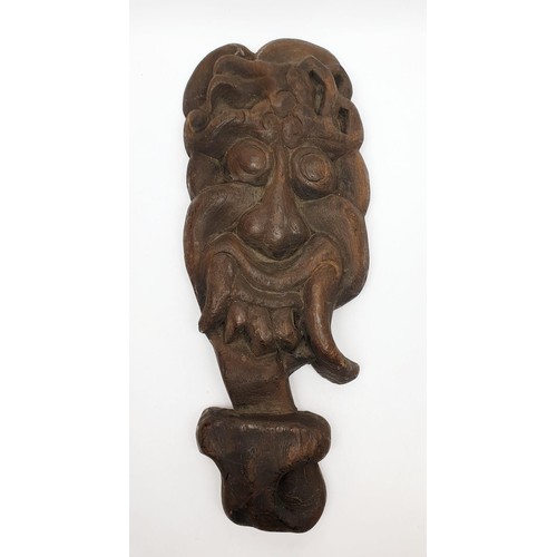 257 - An antique wooden Tibetan wall mask, length 14.5