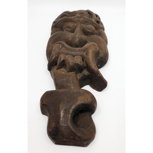 257 - An antique wooden Tibetan wall mask, length 14.5