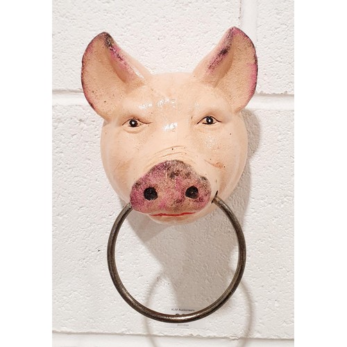 264 - A cast iron wall hanging hook in the form of a pig's head with a ring, length 8.75