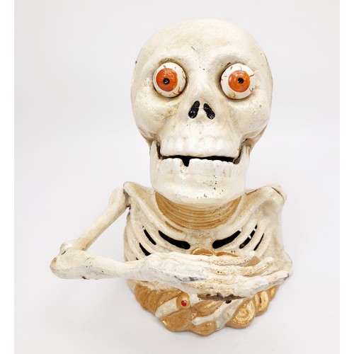 275 - A cast iron skeleton moneybox, height 6.25