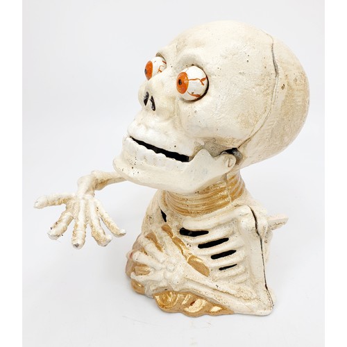 275 - A cast iron skeleton moneybox, height 6.25