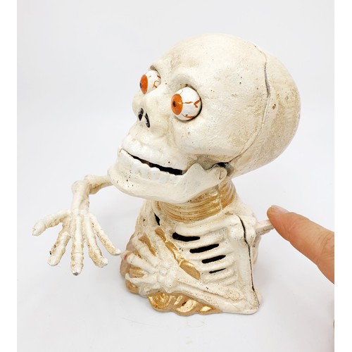 275 - A cast iron skeleton moneybox, height 6.25