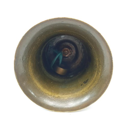 61 - An antique bronze bell, the handle formed as a China man, replacement clapper, height 4