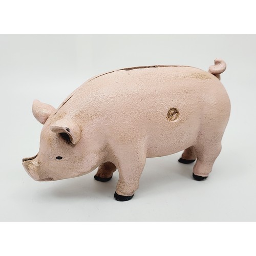 279 - A cast iron pig money box. UK shipping £14.