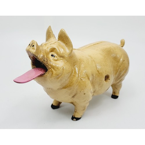 280 - A cast iron  moneybox in the form of coin eating pig. UK shipping £14.