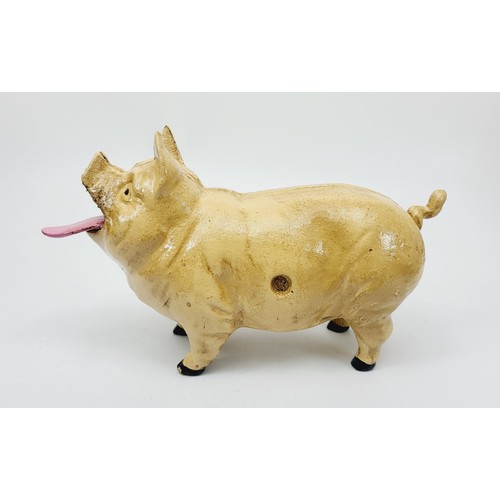 280 - A cast iron  moneybox in the form of coin eating pig. UK shipping £14.