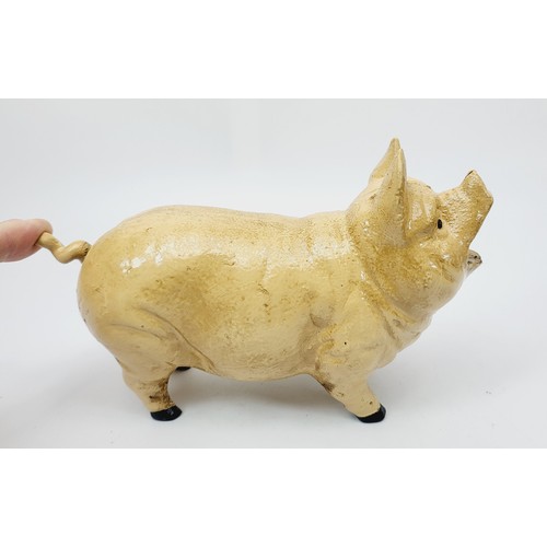 280 - A cast iron  moneybox in the form of coin eating pig. UK shipping £14.