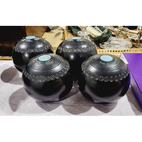 119 - Four Thomas Taylor lawn bowls with bag. UK shipping £14.