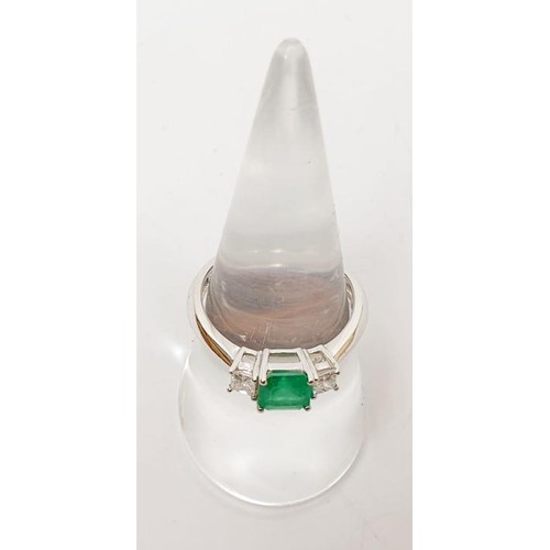 7 - A hallmarked 18ct white gold emerald and diamond three stone dress ring, gross weight 3.5g, size O/P... 