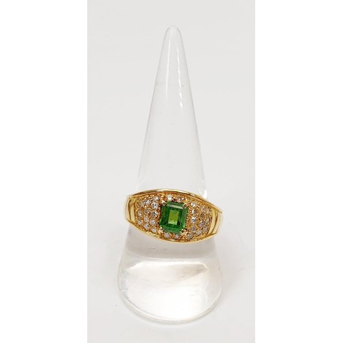 12 - A hallmarked 18ct gold emerald and diamond dress ring, gross weight 7.7g, size T/U. UK shipping £14.