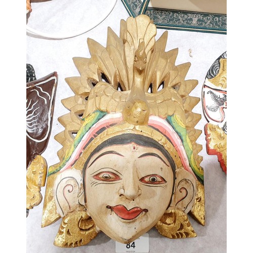 84 - A carved wooden wall mask depicting an eastern deity, length 12