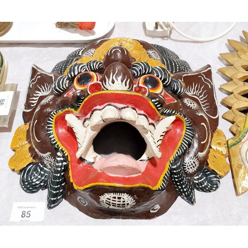 85 - A carved wooden wall mask in the form of an eastern demon, length 12