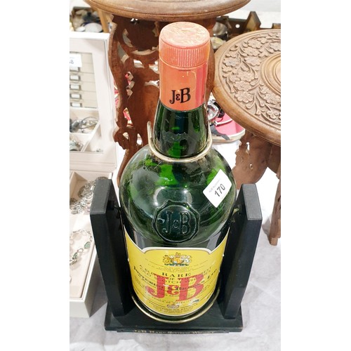 170 - A 3 litre J&B whiskey bottle in a J&B tilting holder, height 18.25