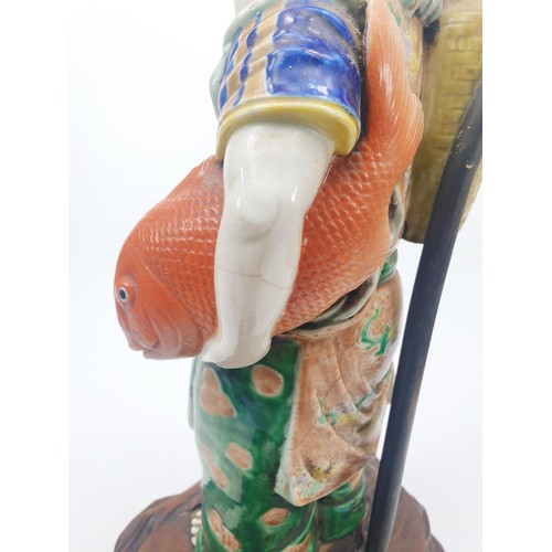 290 - A vintage table lamp with a Chinese ceramic figure, height 18