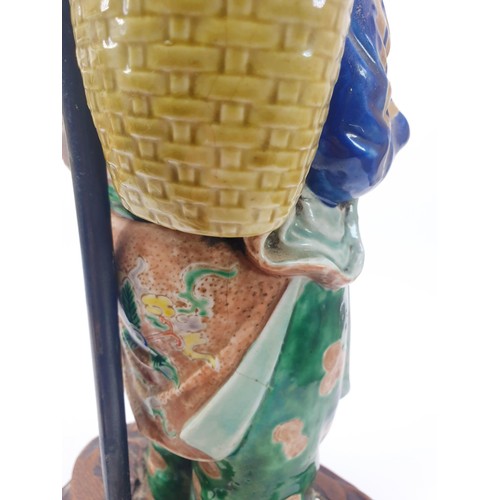 290 - A vintage table lamp with a Chinese ceramic figure, height 18