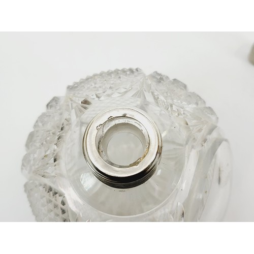 35 - A cut glass scent bottle with a white metal top, height 5.75