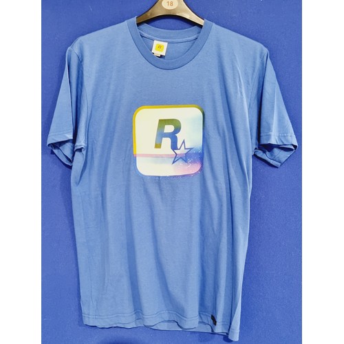 134 - Two Rockstar Games logo grey tee shirts, labeled large but treat as small or child's and a Rockstar ... 