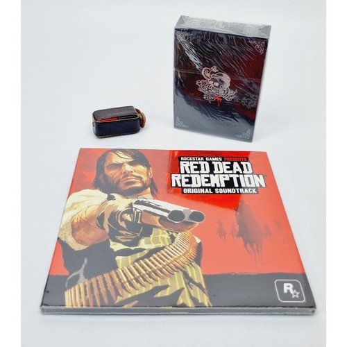 163 - Sealed Red Dead Redemption Playing Cards, Liars dice in a leather pouch and a sealed original soundt... 