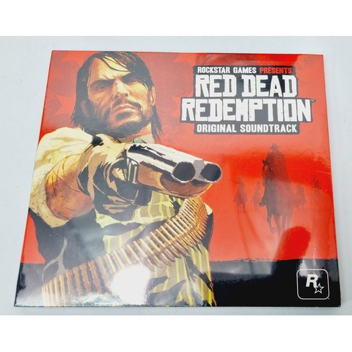 163 - Sealed Red Dead Redemption Playing Cards, Liars dice in a leather pouch and a sealed original soundt... 