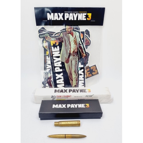 198 - Max Payne 3 promotional items: Painkillers pill box, a boxed gold bullet pen and assorted stickers, ... 