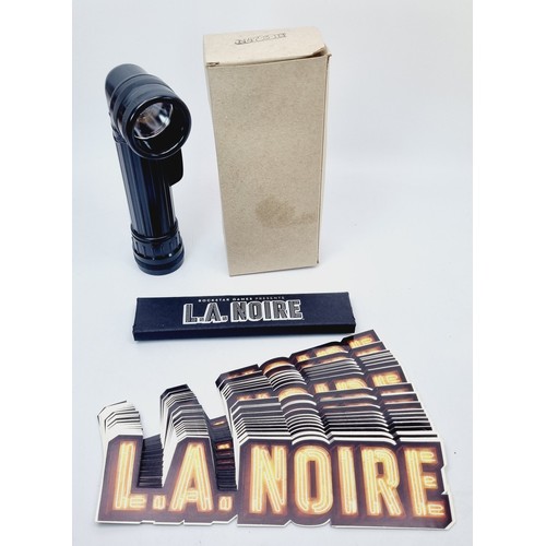 201 - LA Noire promotional items: a boxed N473-3-1B flashlight, a pack of pencils and twenty stickers. UK ... 