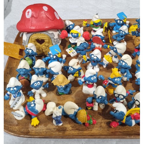 219 - Approximately seventy five Smurf figures by Peyo/Schleich. UK shipping £14.