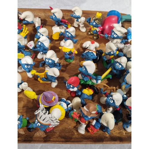 219 - Approximately seventy five Smurf figures by Peyo/Schleich. UK shipping £14.