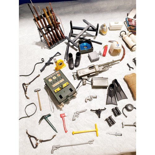 263 - A selection of vintage Action Man weapons and accessories including a field radio. UK shipping £14.