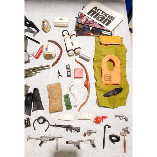 263 - A selection of vintage Action Man weapons and accessories including a field radio. UK shipping £14.