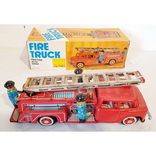 312 - A vintage tin plate push along MF718 fire engine with original box lid. UK shipping £14.