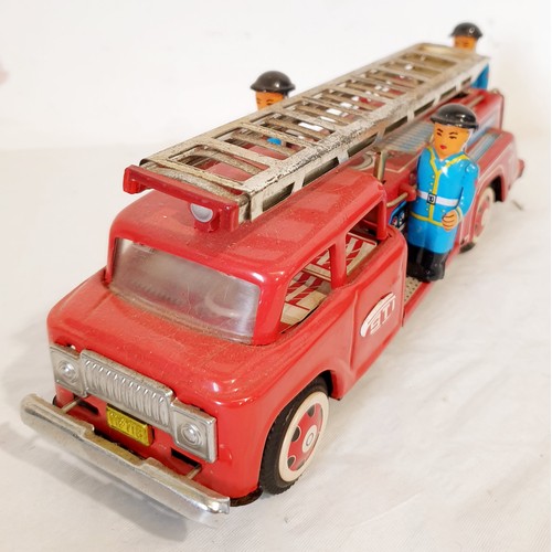 312 - A vintage tin plate push along MF718 fire engine with original box lid. UK shipping £14.