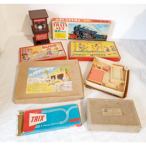 318 - Vintage boxed games and toys including a Cosmo Train Set, Trix train, track and others. UK shipping ... 